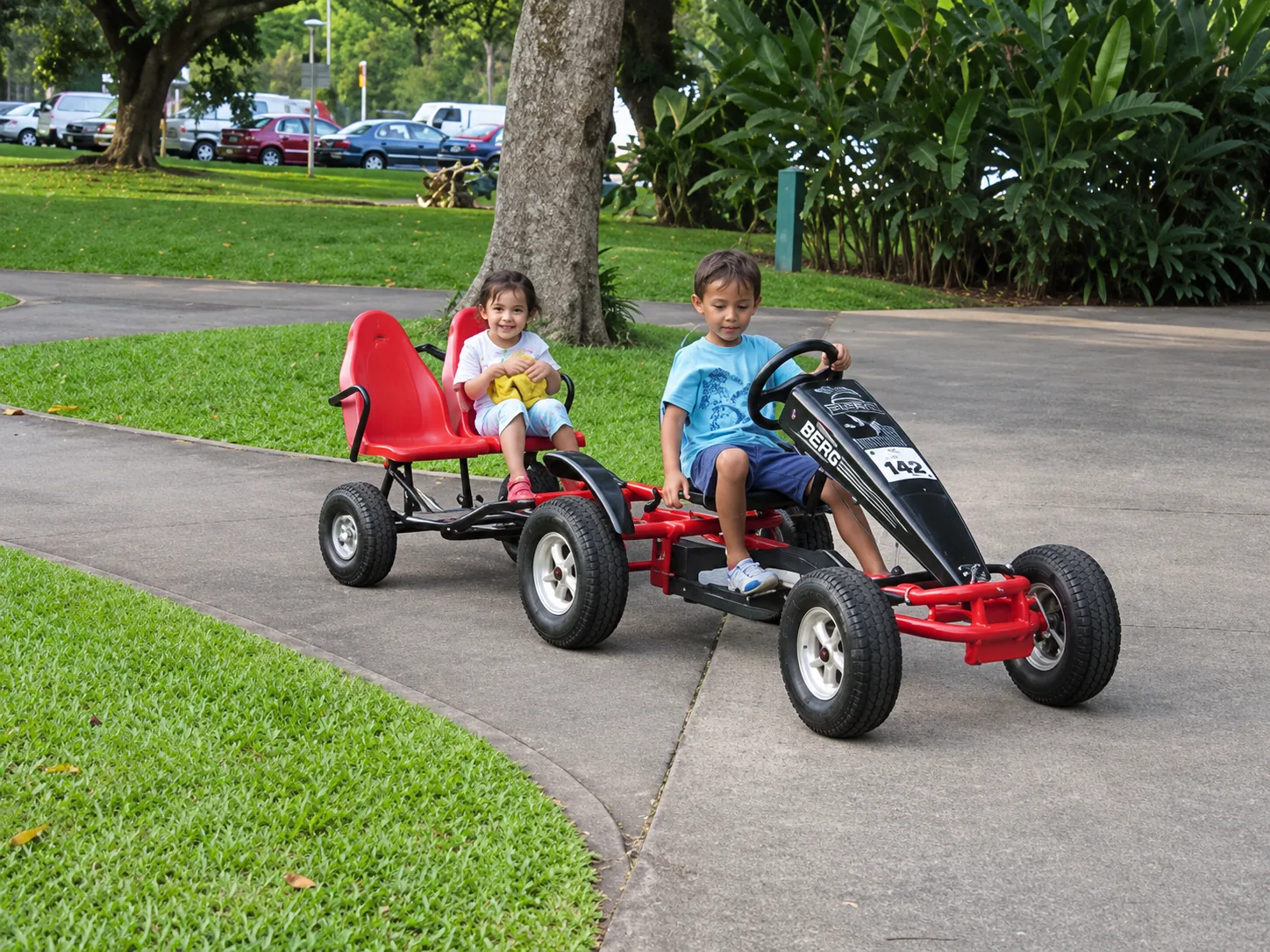 Children riding a long pedal go-kart during an event in Singapore